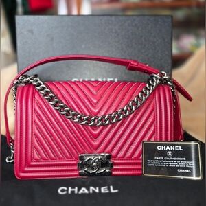 Chanel Boy Flap Bag in Red Chevron Calfskin Leather with Ruthenium Hardware.